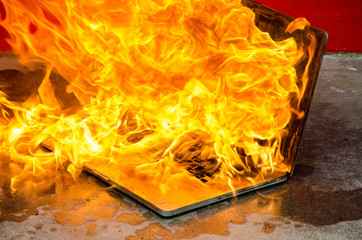 Laptop computer engulfed in fire and flames
