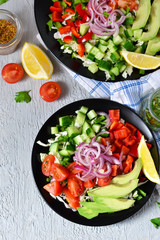 Vegetable salad with avocado and mustard sauce on a concrete, gray background