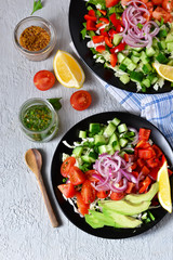 Vegetable salad with avocado and mustard sauce on a concrete, gray background