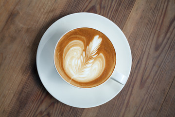 latte art coffee on wood background.Vintage Style