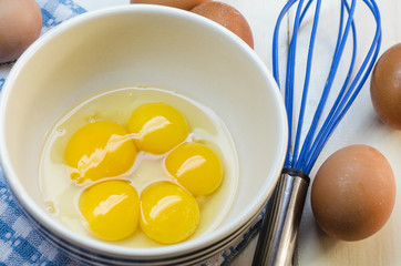 Raw eggs and whisk