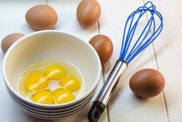 Raw eggs and whisk