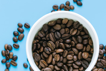 coffee beans in the Blank Paper cup on the blue background 