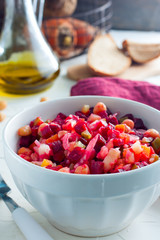 Vinaigrette with turkey peas (chickpeas) in a white bowl, selective focus