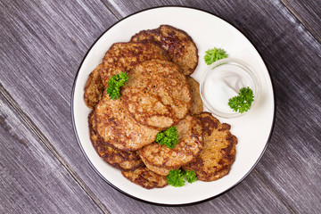 Liver Patties with Sour Cream and Parsley. Liver Cakes or Fritters of Liver. Healthy snack or take-away lunch bites. View from above, top studio shot