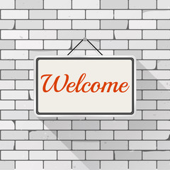 Obraz premium Simple white sign with text 'Welcome' hanging on a gray brick wall. Grunge brickwork background, textured rough surface. Creative business interior template for shop, store, supermarket.