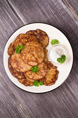 Liver Patties with Sour Cream and Parsley. Liver Cakes or Fritters of Liver. Healthy snack or take-away lunch bites. View from above, top studio shot