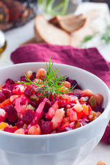 Vinaigrette with turkey peas (chickpeas) in a white bowl, selective focus