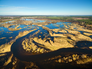 Fototapeta na wymiar Aerial panoramic view of flooded blue river in spring