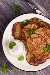 Liver Patties with Sour Cream and Parsley. Liver Cakes or Fritters of Liver. Healthy snack or take-away lunch bites. View from above, top studio shot