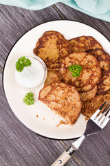 Liver Patties with Sour Cream and Parsley. Liver Cakes or Fritters of Liver. Healthy snack or take-away lunch bites. View from above, top studio shot