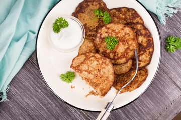 Liver Patties with Sour Cream and Parsley. Liver Cakes or Fritters of Liver. Healthy snack or take-away lunch bites. View from above, top studio shot