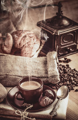 Cup fragrant hot coffee with bean chocolate sweet and croissant