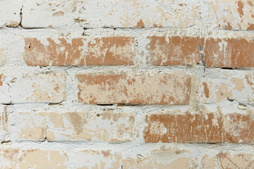 Background of old vintage dirty brick wall with peeling plaster, texture