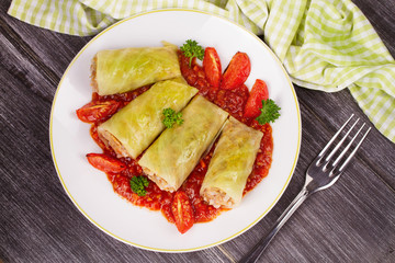 Cabbage rolls with meat, rice and vegetables in tomato sauce. Stuffed cabbage leaves with meat. Dolma, sarma, sarmale, golubtsy or golabki - traditional and popular dish in many countries