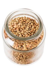 green lentils in open jar on a white background