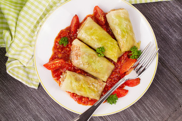 Cabbage rolls with meat, rice and vegetables in tomato sauce. Stuffed cabbage leaves with meat. Dolma, sarma, sarmale, golubtsy or golabki - traditional and popular dish in many countries