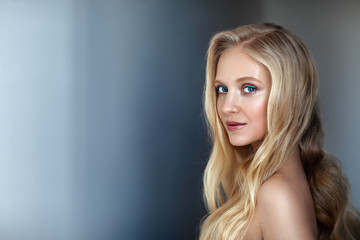 Beauty portrait of nordic natural blonde woman on dark background