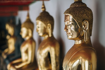 Row of golden buddha statues Bangkok