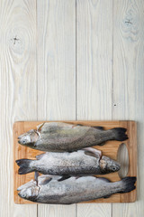 Raw trout on a wooden background