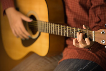Obraz na płótnie Canvas women playing acoustic guitar close-up