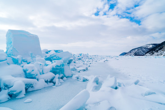 Row of ice blocks and the mountain covering with snow at lake Baikal