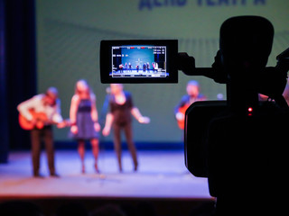 Shooting concert video. Control monitor. Blurred background, bokeh. Videography.