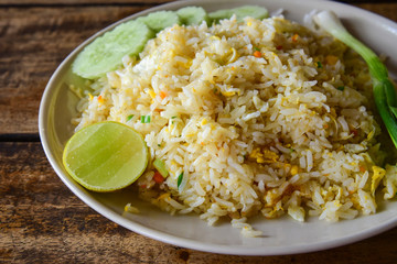 Fried rice with eggs on wooden table