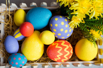 Colorful easter decorative eggs in wooden box