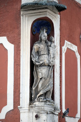 Fototapeta na wymiar Virgin Mary with baby Jesus, statue on the house facade in Ptuj, town on the Drava River banks, Lower Styria Region, Slovenia 
