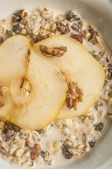 Oatmeal with pear and walnuts in the bowl