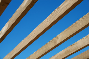 Wooden rafters against the blue sky
