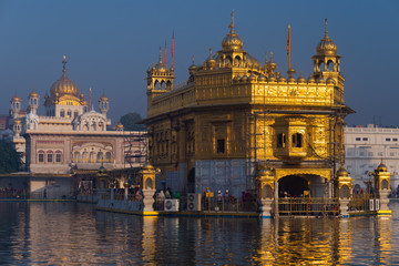 The Golden Temple at Amritsar, Punjab, India, the most sacred icon and worship place of Sikh religion. Sunset light reflected on lake.