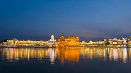 The Golden Temple at Amritsar, Punjab, India, the most sacred icon and worship place of Sikh religion. Illuminated in the night, reflected on lake.