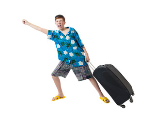 Young boy in a shirt and shorts is dragging a suitcase and joyfully shouts showing a fist on a white background