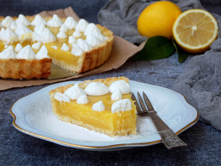 Lemon tart pie with meringue cream. Homemade cake on grey background. Horizontal photo