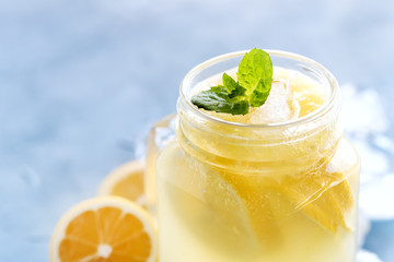 Close up mug jar with citrus lemonade Ice cube Mint leaf on top 