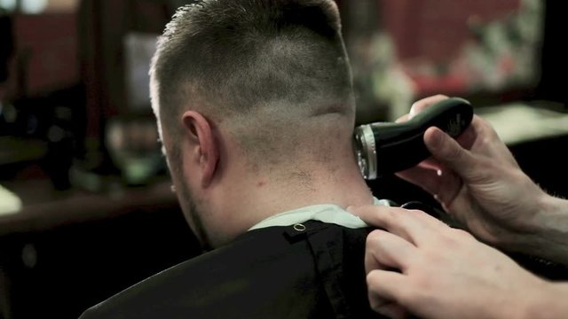 Barber Cuts the Hair in the Barbershop. Slow Motion.