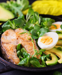 Grilled sheatfish fish steak with avocado, arugula and salad