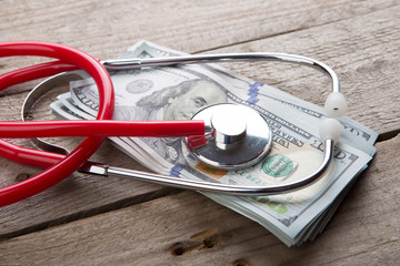 health insurance concept - stethoscope over the money