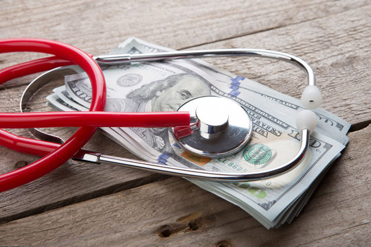 health insurance concept - stethoscope over the money