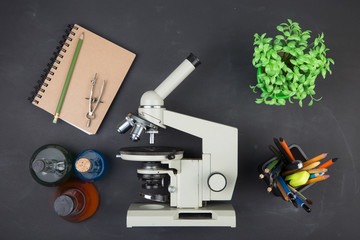 Education concept books and microscope on the desk in the auditorium