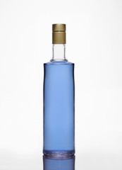 Transparent glass bottle with blue liquid