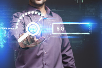 Business, Technology, Internet and network concept. Young businessman working on a virtual screen of the future and sees the inscription: 5G