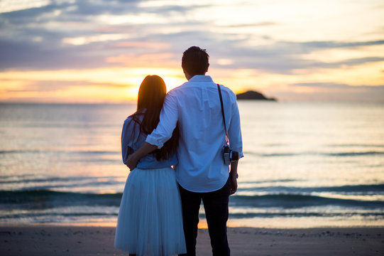 Happy Romantic young Couple Enjoying Beautiful Sunset