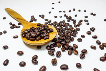 coffee bean in wooden spoon on white background