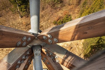 Wooden beams with screws in the structure. Assembling and connecting wooden beams. Detail of...