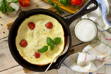 Breakfast background. Scrambled eggs with fresh tomatoes and suluguni cheese. The concept of a healthy diet and diet.