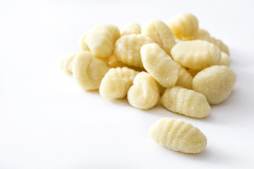 Uncooked potato gnocchi isolated on white background
