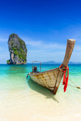 Thailand summer travel sea, Thai old wood boat at sea beach Krabi Phi Phi Island Phuket park on white sand blue sky emerald green ocean water.